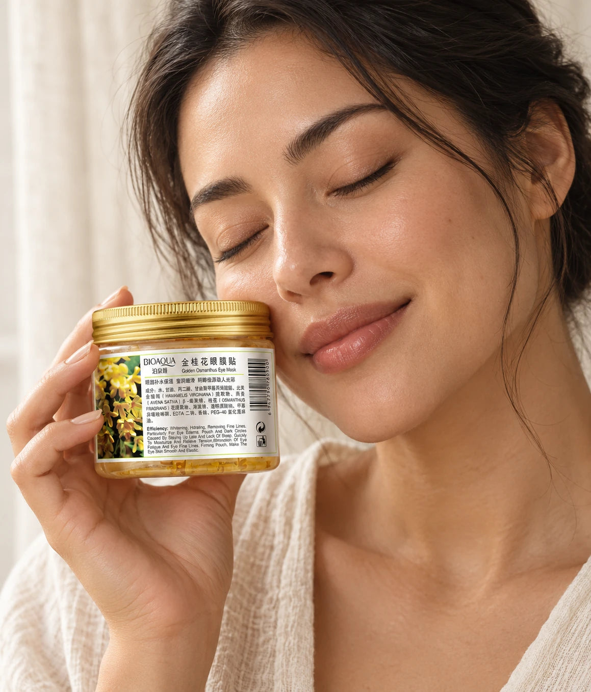 Woman holding BIOAQUA Golden Osmanthus Eye Mask jar
