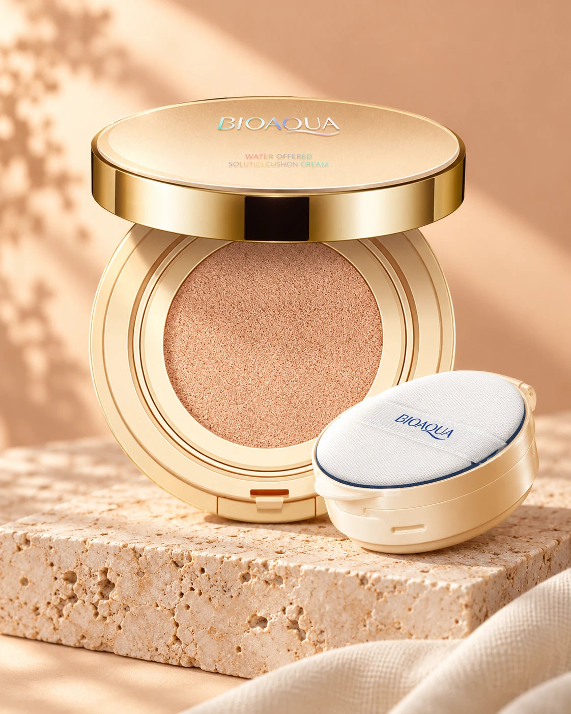 BIOAQUA golden cushion compact and puff on a warm stone pedestal